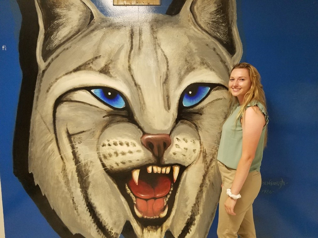 Student in front of Large Cat Painting