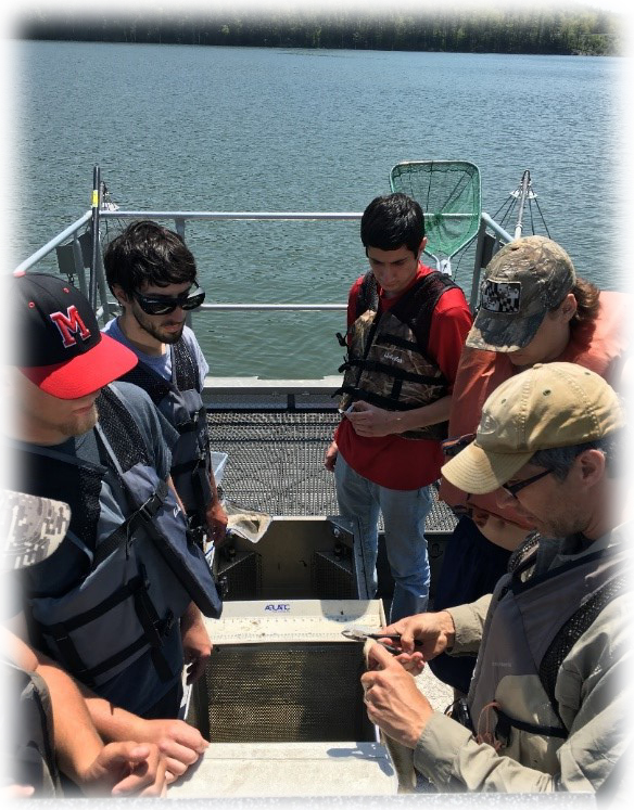 Students on boat conducting tests