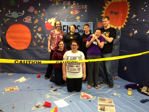 Students stand at a mock crime scene