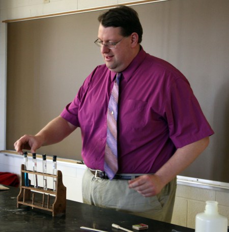 Professor showing test tubes to students