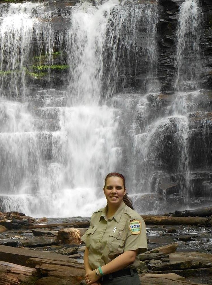Park Ranger Summers standing in front of waterfall
